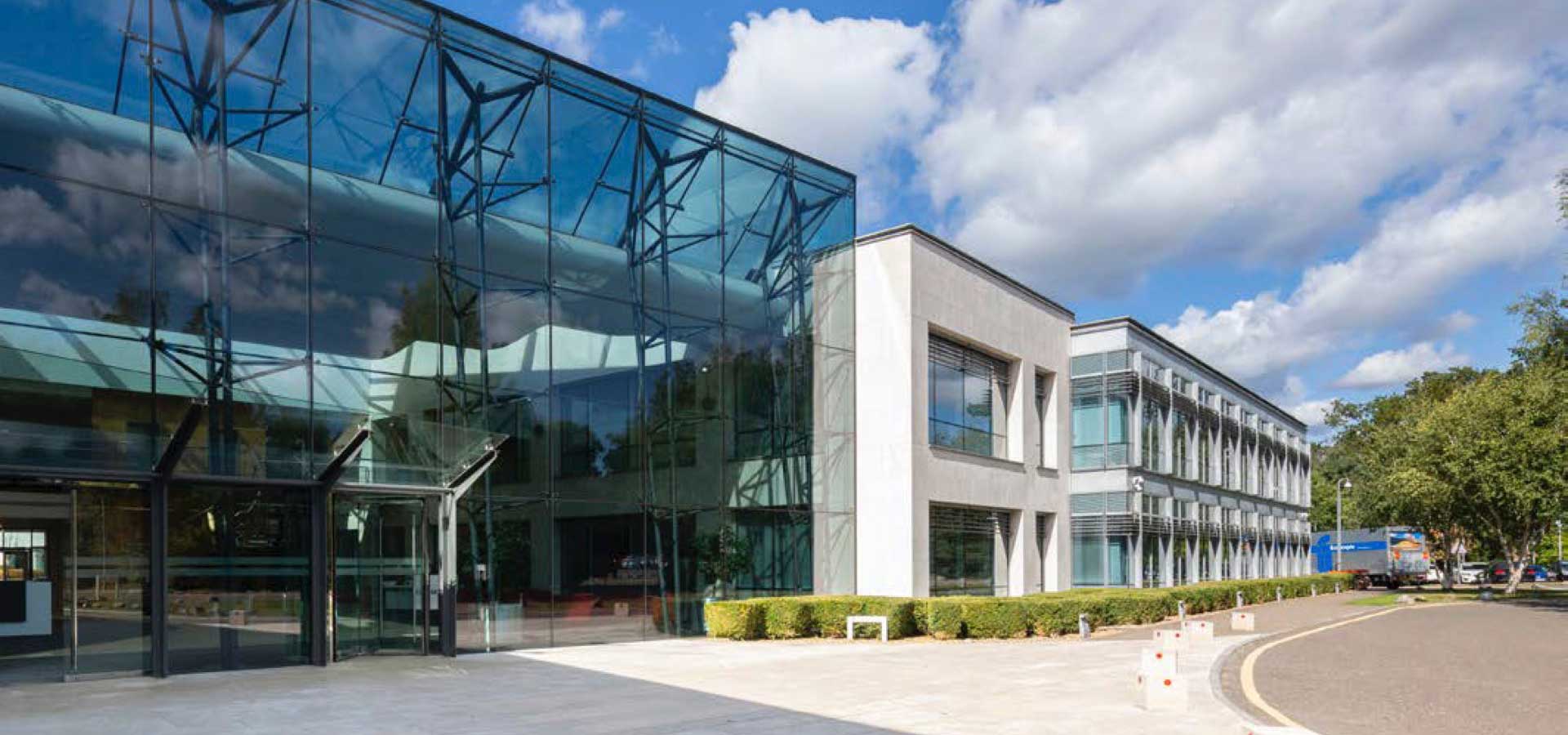 Exterior of a modern corporate building with glass wall